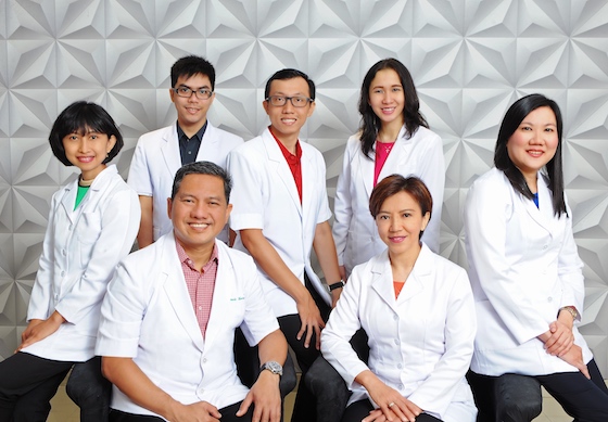 seven dentists smiling at the camera
